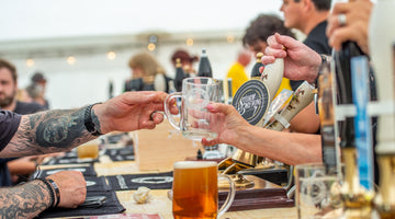 beer being served in tankards at the bar at one of our festivals