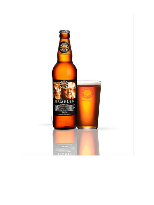 A bottle of Rambler beer next to a pint glass, both filled with the Rambler beer to demonstrate the colour as a style indicator. Set against a plain white background with a soft reflection below.